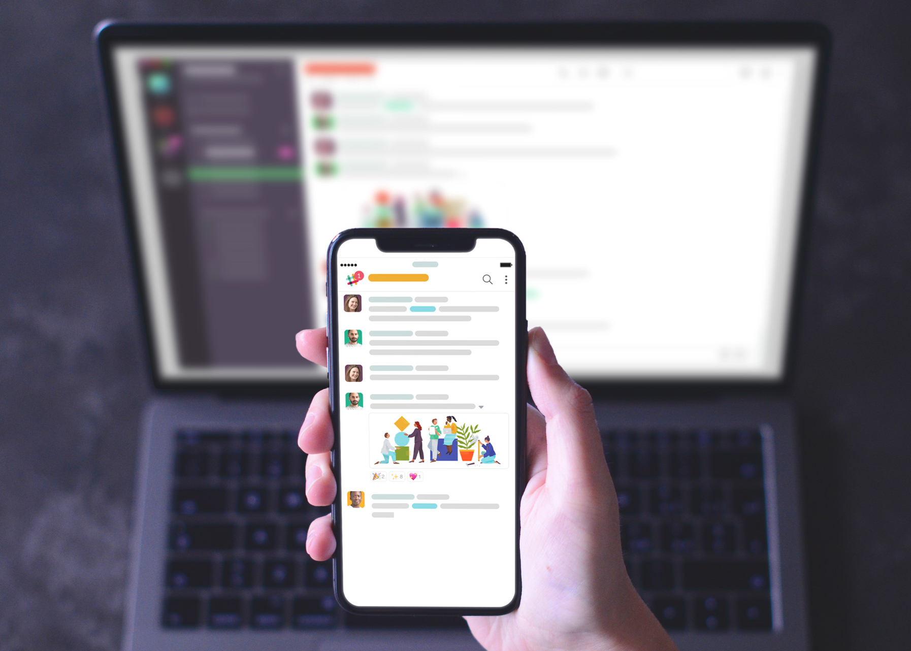 Stock photo of Slack being used on laptop and phone